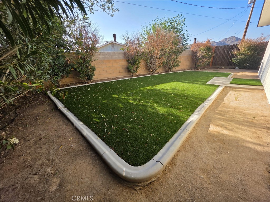 15354 Kiamichi Road Apple Valley, CA 92307 - Photo 19 of 22 a view of a backyard with plants and a lake view