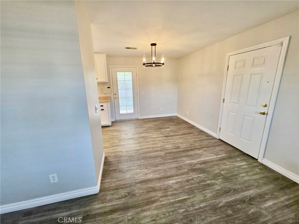 15354 Kiamichi Road Apple Valley, CA 92307 - Photo 6 of 22 a view of a hallway with wooden floor