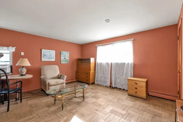 a view of a livingroom with furniture and a window