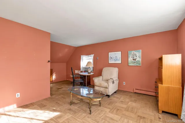 a living room with furniture a couch and a dining table with rug