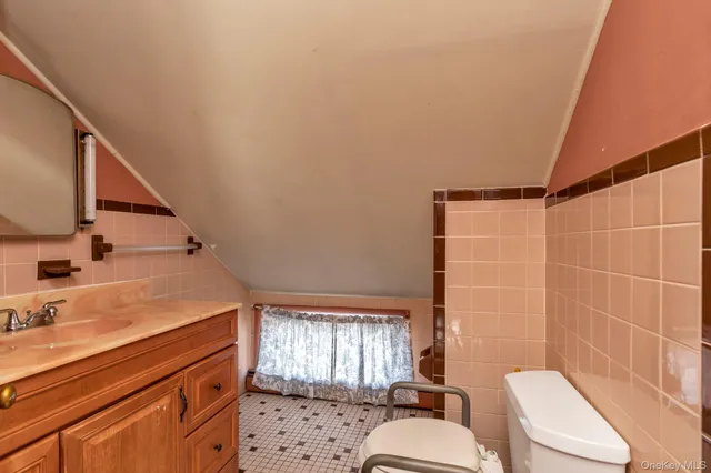 a bathroom with a sink toilet vanity and tub