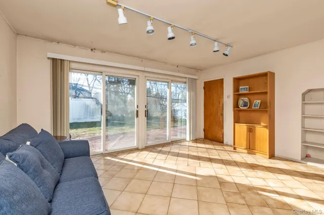 a living room with furniture and large windows