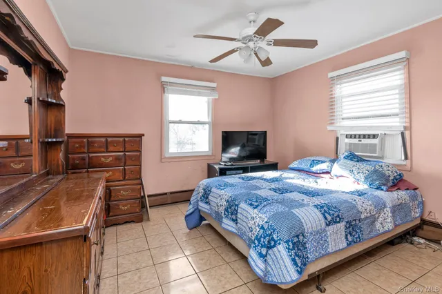 a bedroom with a bed and a tv on the dresser