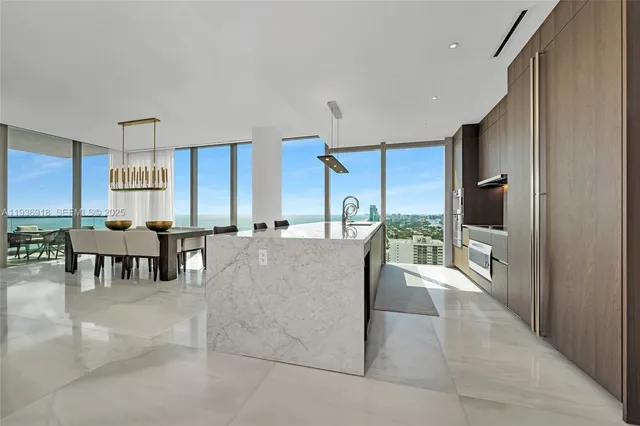 a view of kitchen with dining area refrigerator and window