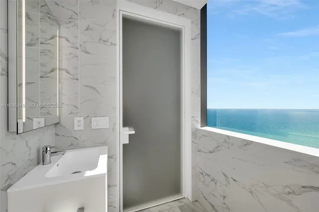 a bedroom with furniture and a large window