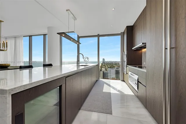 a view of a kitchen with a sink and a large window