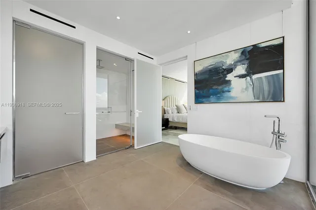 a bathroom with a tub shower and sink