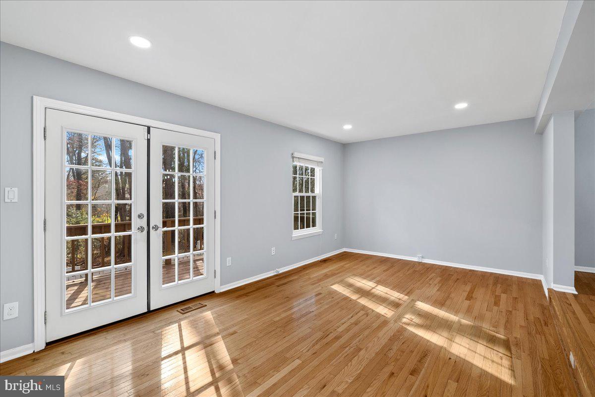 1481 Autumn Ridge Circle Reston, VA 20194 - Photo 11 of 26 a view of an empty room with a window and wooden floor