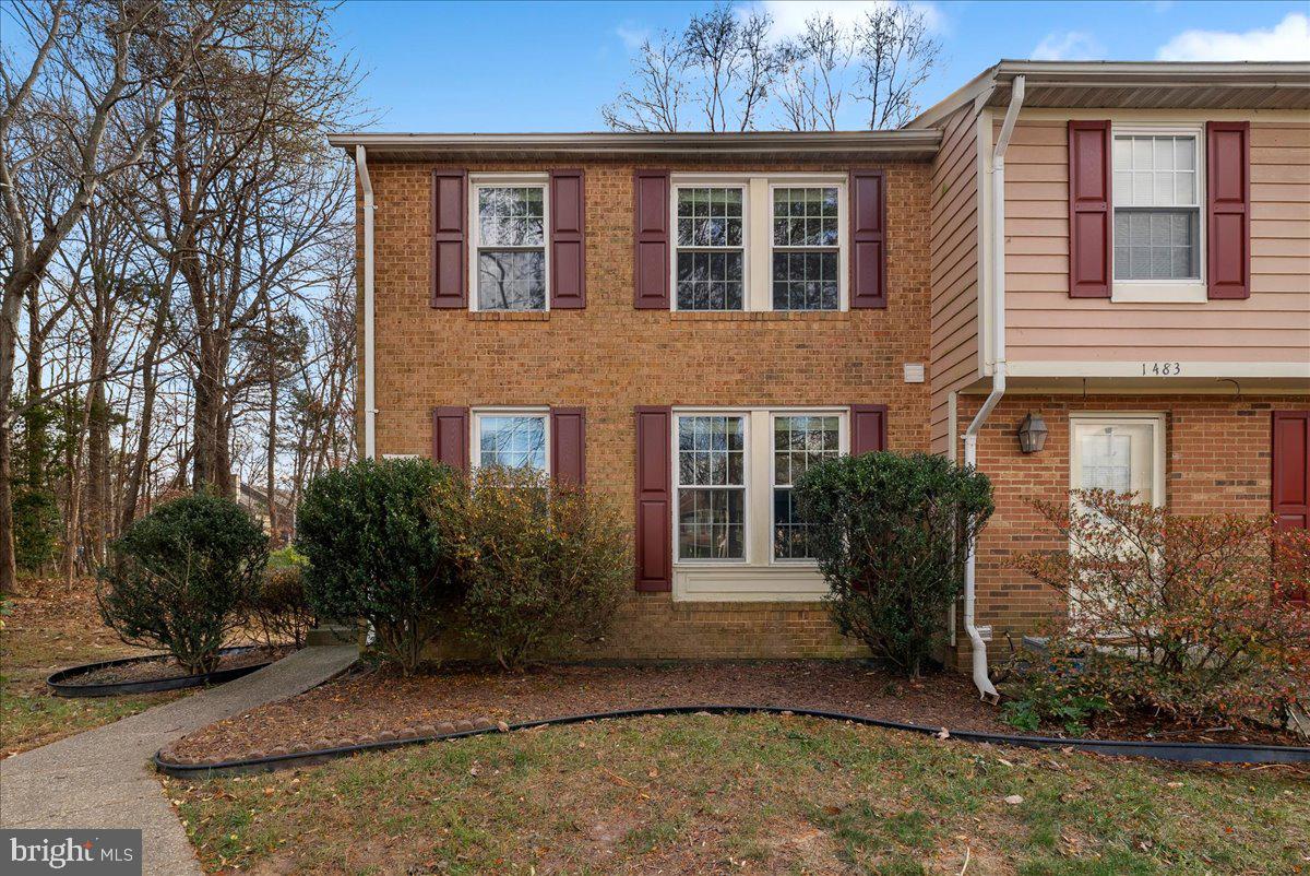 1481 Autumn Ridge Circle Reston, VA 20194 - Photo 2 of 26 a view of a brick building next to a yard