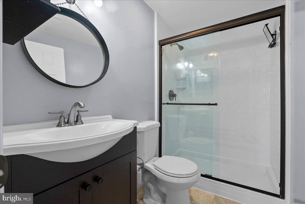 1481 Autumn Ridge Circle Reston, VA 20194 - Photo 22 of 26 a bathroom with a sink mirror toilet and shower