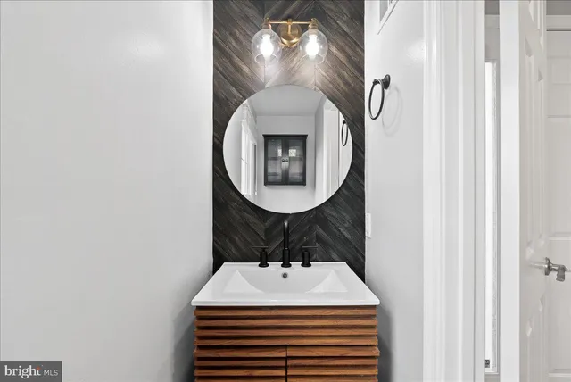 a kitchen with granite countertop a sink cabinets and stainless steel appliances