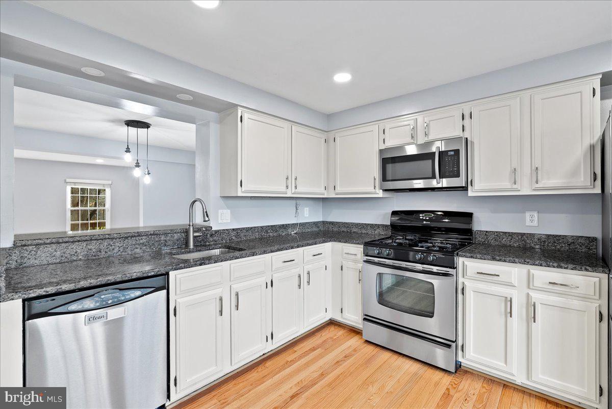 1481 Autumn Ridge Circle Reston, VA 20194 - Photo 5 of 26 a kitchen with granite countertop a sink cabinets and stainless steel appliances