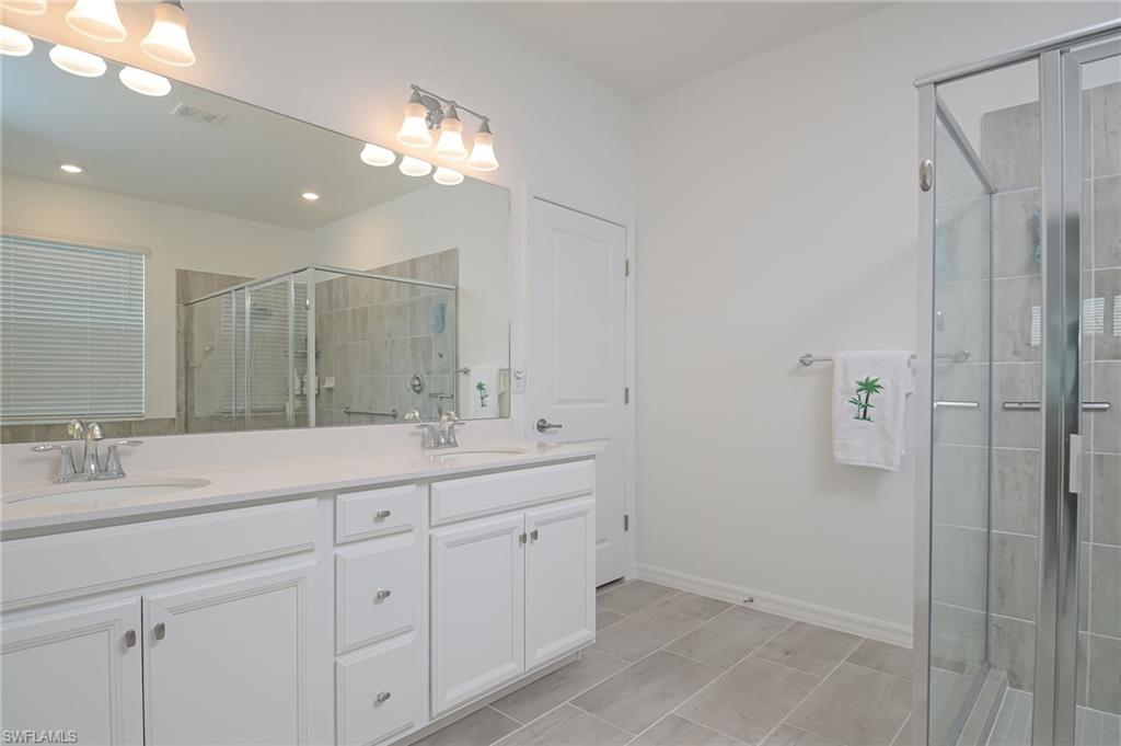 2532 Kona Way Naples, FL 34120 - Photo 11 of 30 a bathroom with a double vanity sink and mirror