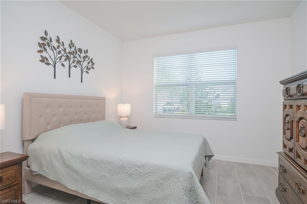 2532 Kona Way Naples, FL 34120 - Photo 14 of 30 a bedroom with a bed and a window