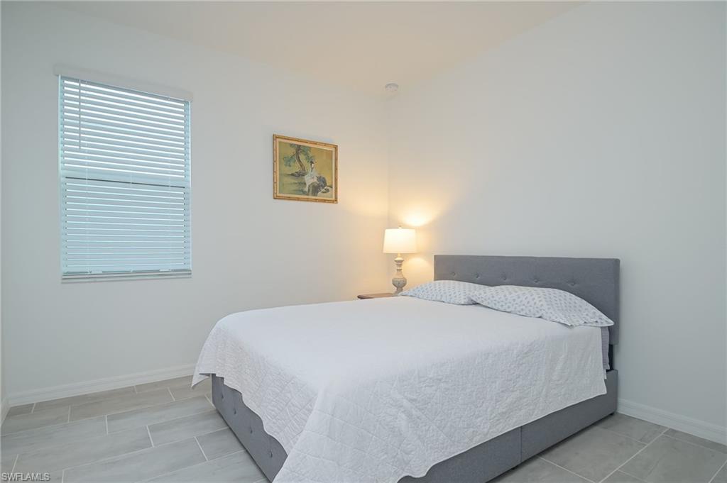 2532 Kona Way Naples, FL 34120 - Photo 16 of 30 a bedroom with a bed and a window