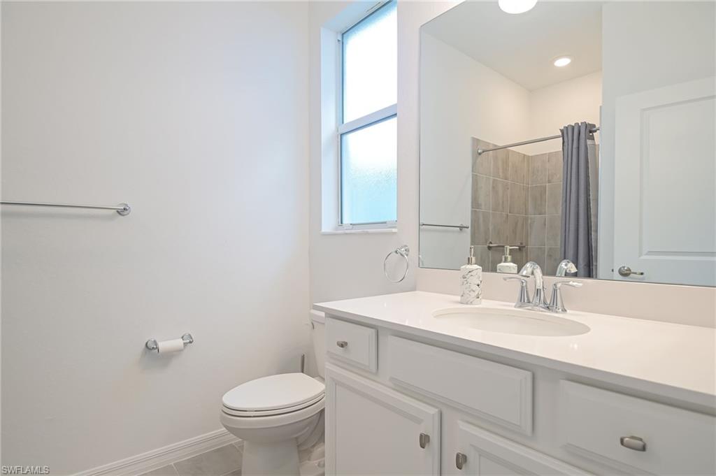 2532 Kona Way Naples, FL 34120 - Photo 17 of 30 a bathroom with a sink toilet and a mirror