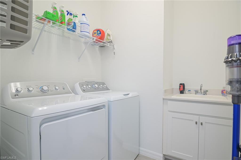 2532 Kona Way Naples, FL 34120 - Photo 18 of 30 a utility room with dryer and washer