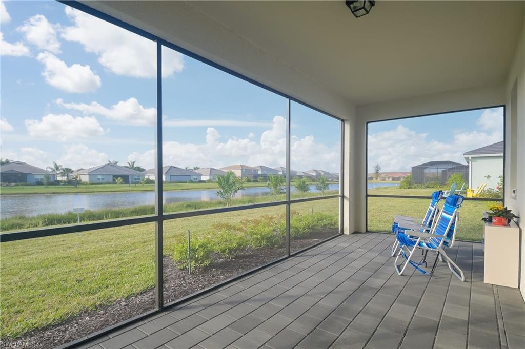 2532 Kona Way Naples, FL 34120 - Photo 19 of 30 a view of a room with a table chairs and balcony