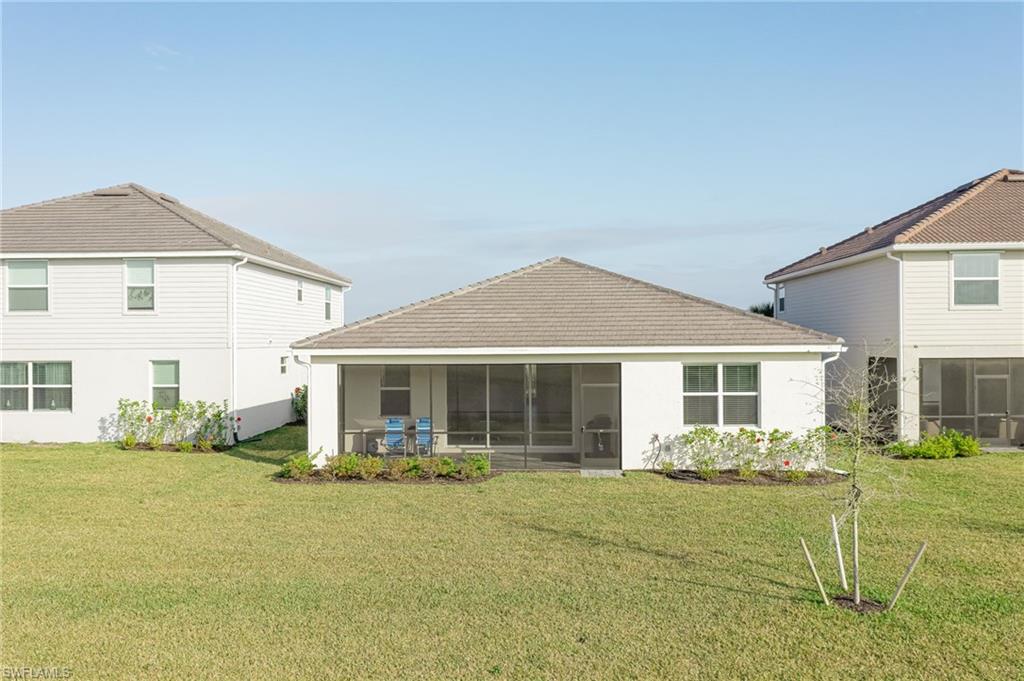 2532 Kona Way Naples, FL 34120 - Photo 22 of 30 a front view of a house with a yard