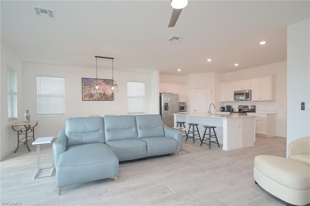 2532 Kona Way Naples, FL 34120 - Photo 3 of 30 a living room with furniture and kitchen view