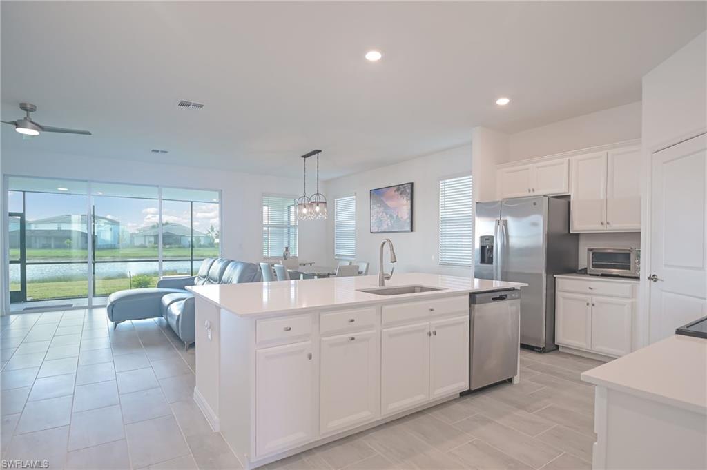 2532 Kona Way Naples, FL 34120 - Photo 5 of 30 a open kitchen with stainless steel appliances granite countertop a sink and cabinets