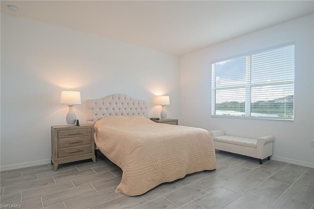 2532 Kona Way Naples, FL 34120 - Photo 9 of 30 a bedroom with a bed and a window