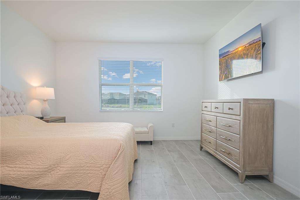 2532 Kona Way Naples, FL 34120 - Photo 10 of 30 a bedroom with a bed and a window