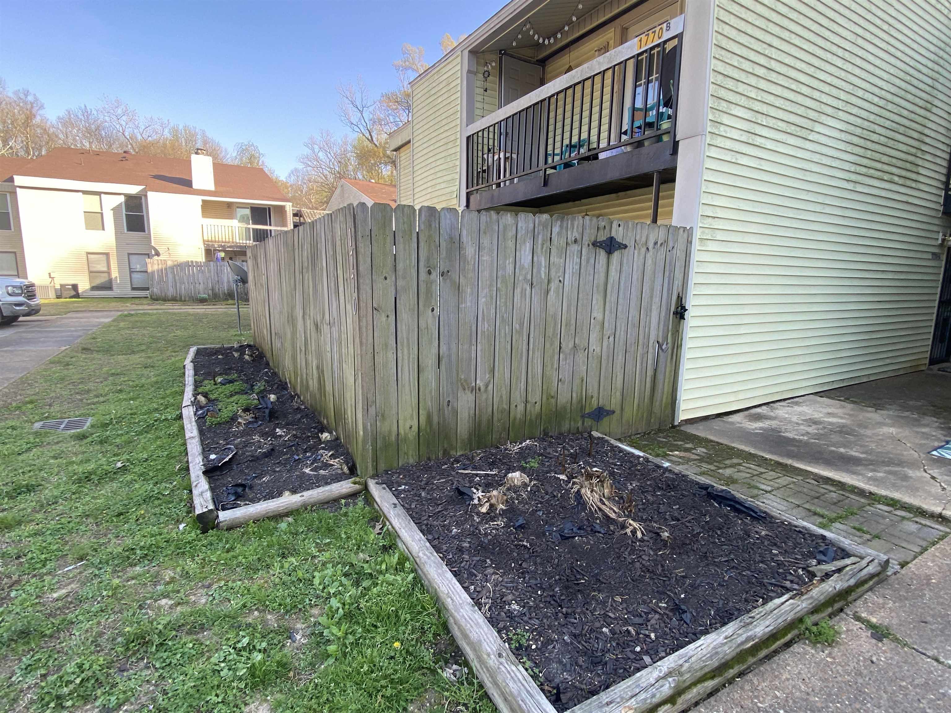 1770 Crompton 6th Square, Unit 29 Memphis, TN 38134 - Photo 21 of 21 View of yard featuring a balcony, a vegetable garden, and a patio area