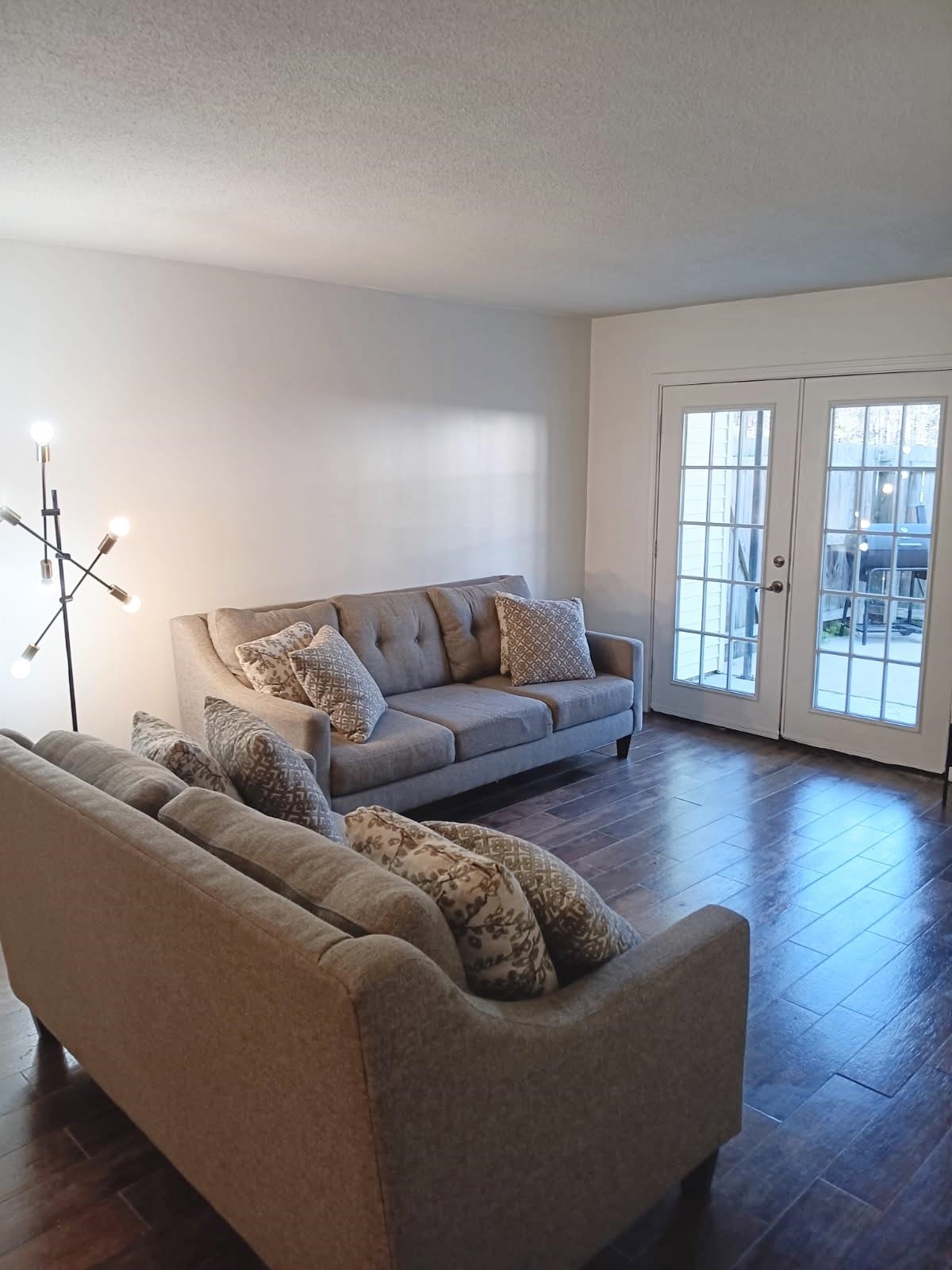 1770 Crompton 6th Square, Unit 29 Memphis, TN 38134 - Photo 4 of 21 Living area with dark wood-style floors, french doors, and a textured ceiling