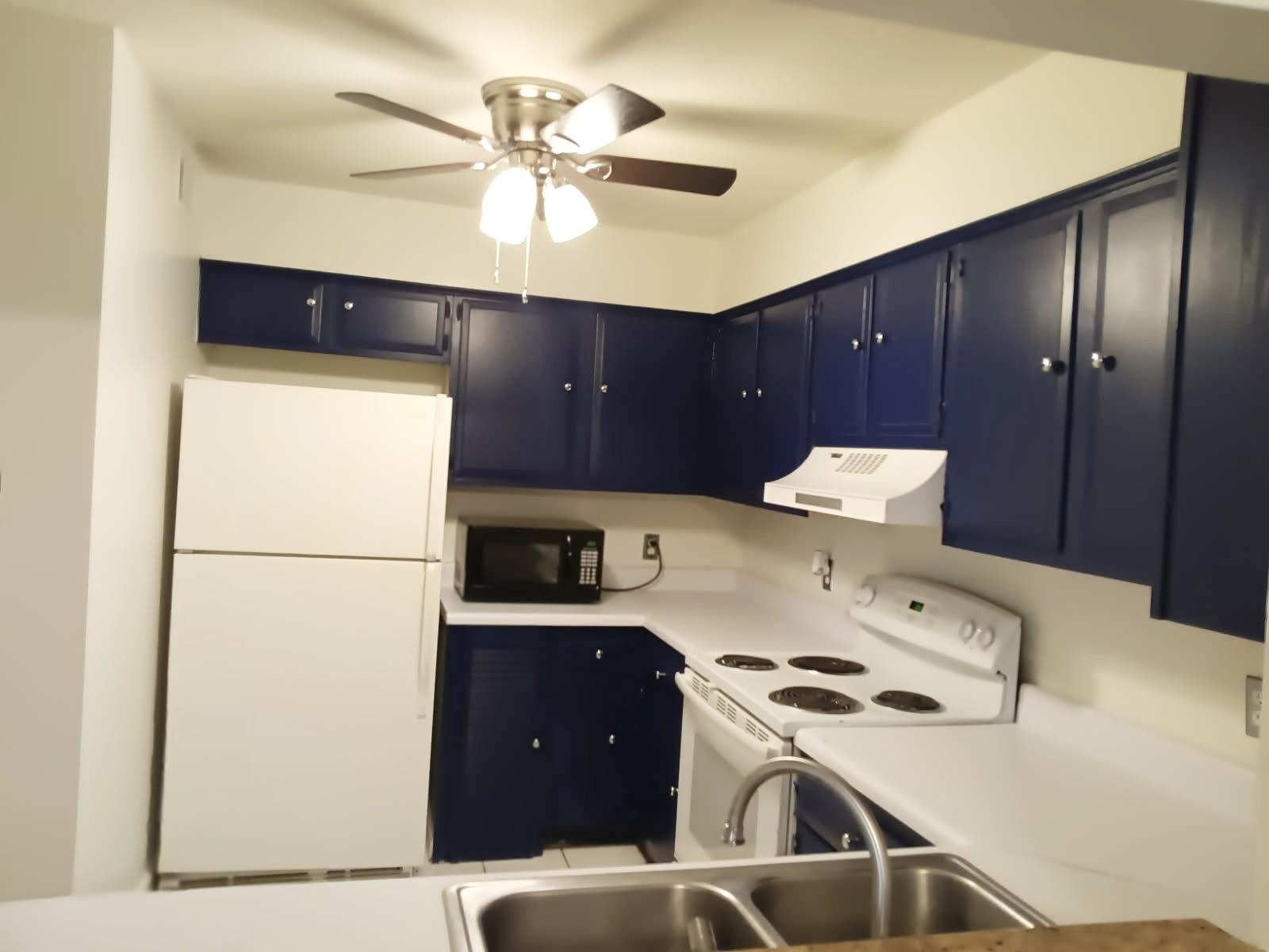 1770 Crompton 6th Square, Unit 29 Memphis, TN 38134 - Photo 7 of 21 Kitchen with white appliances, light countertops, ventilation hood, blue cabinets, and ceiling fan