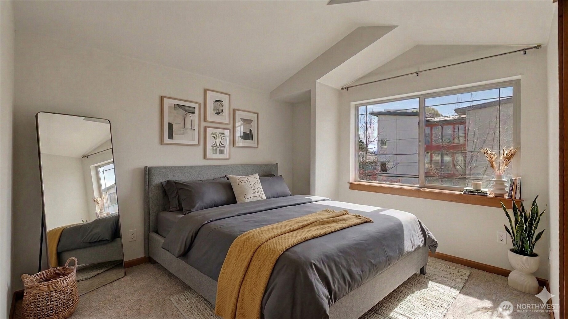 1120 North 92nd Street, Unit A Seattle, WA 98103 - Photo 14 of 22 a bedroom with a large bed and a potted plant