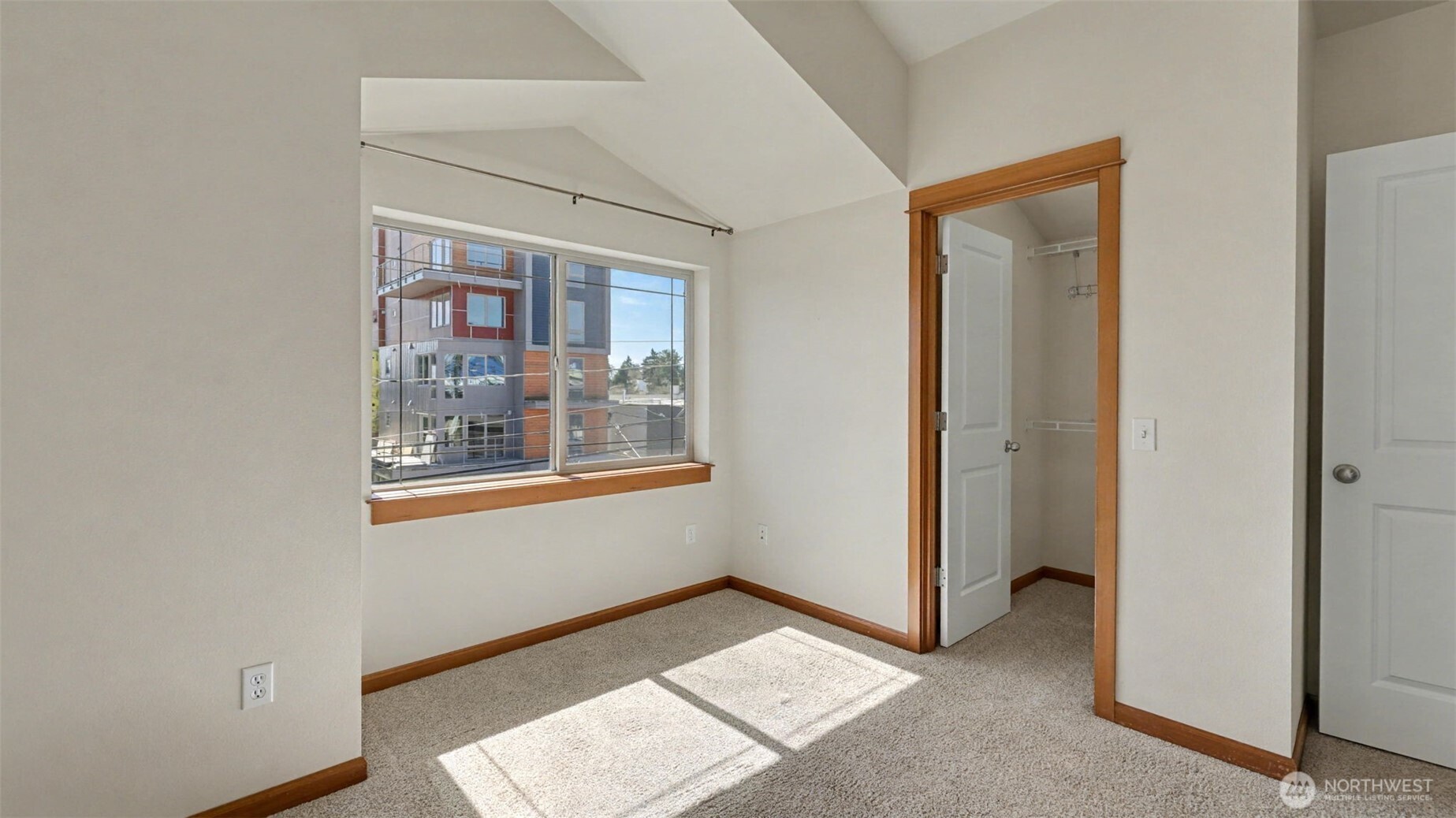 1120 North 92nd Street, Unit A Seattle, WA 98103 - Photo 16 of 22 a view of an empty room with window and wooden floor
