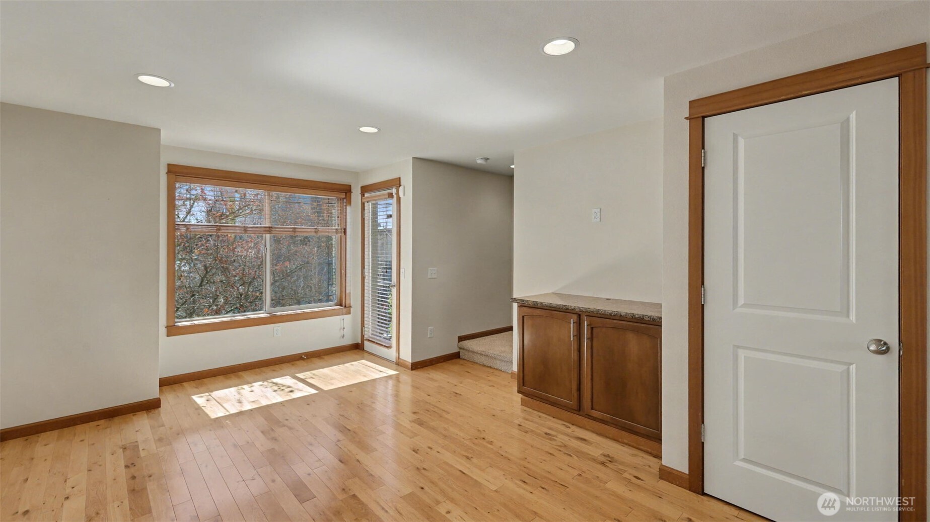 1120 North 92nd Street, Unit A Seattle, WA 98103 - Photo 10 of 22 wooden floor in an empty room with a window