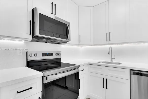 a kitchen with a stove microwave and sink