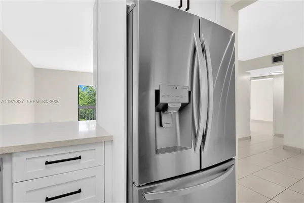a kitchen with a refrigerator and cabinets
