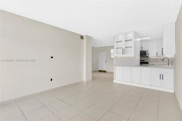 a view of kitchen with white cabinets
