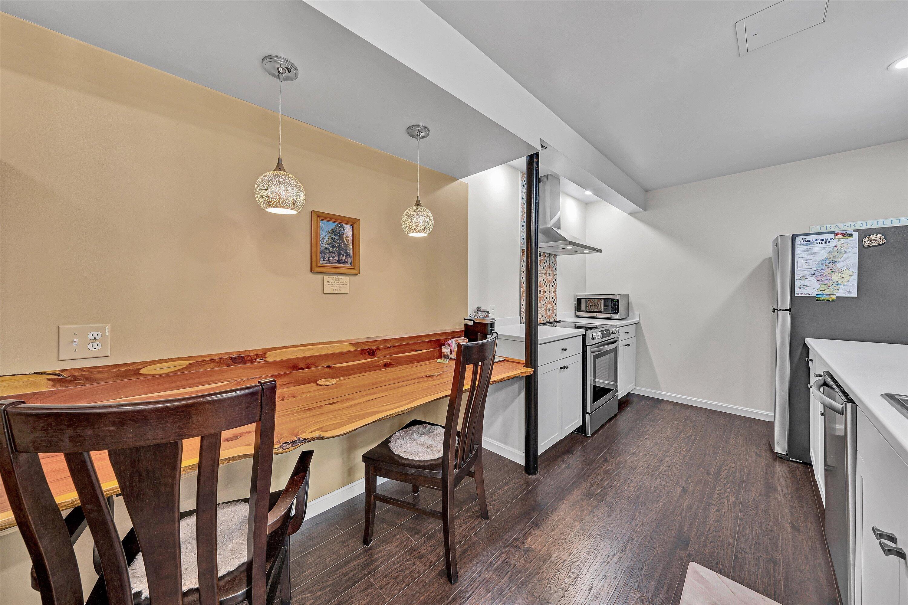 1124 Old Hollow Road Buchanan, VA 24066 - Photo 50 of 73 a view of a dining room with furniture and wooden floor
