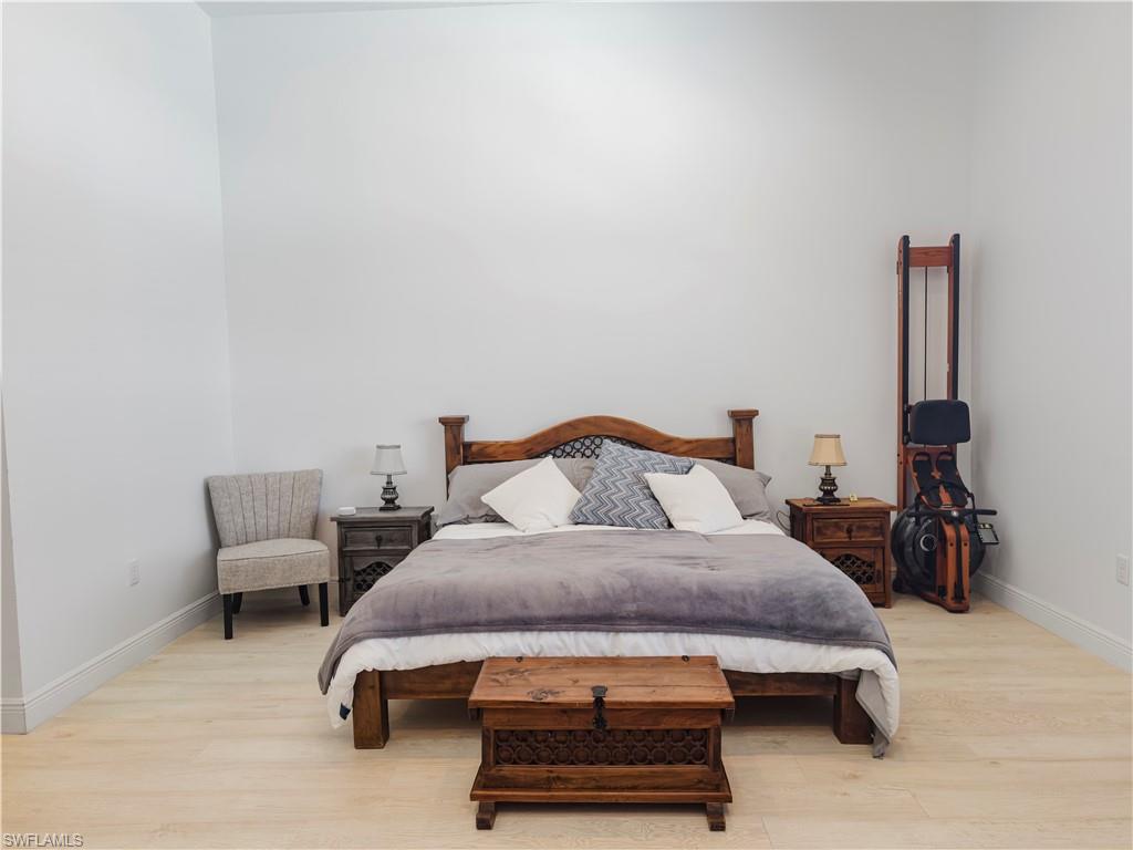 5169 Roma Street South Ave Maria, FL 34142 - Photo 21 of 49 a bedroom with a bed and a chair