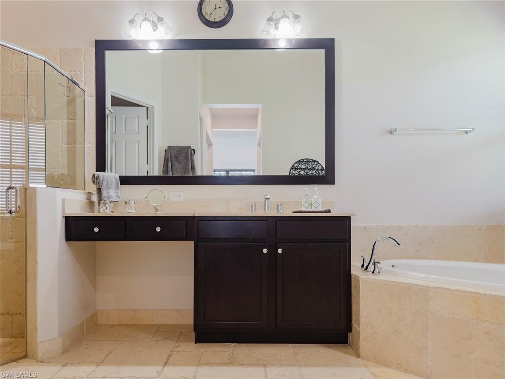 5169 Roma Street South Ave Maria, FL 34142 - Photo 26 of 49 a bathroom with a bathtub sink and mirror