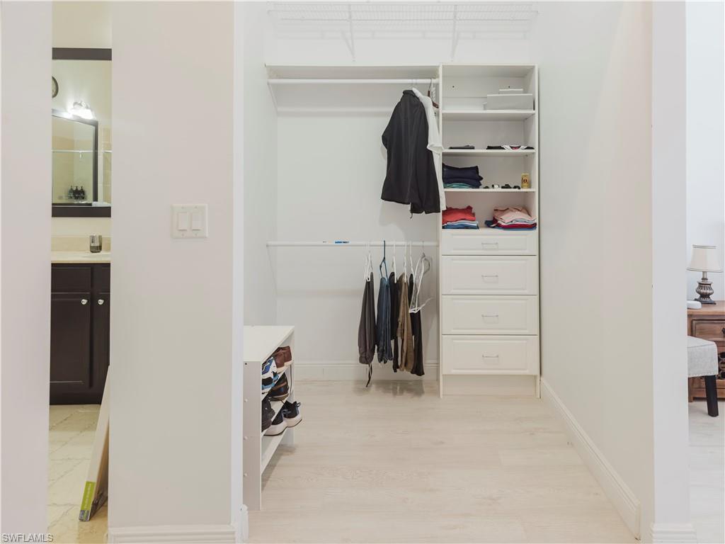 5169 Roma Street South Ave Maria, FL 34142 - Photo 29 of 49 a view of walk in closet with clothes and shoes