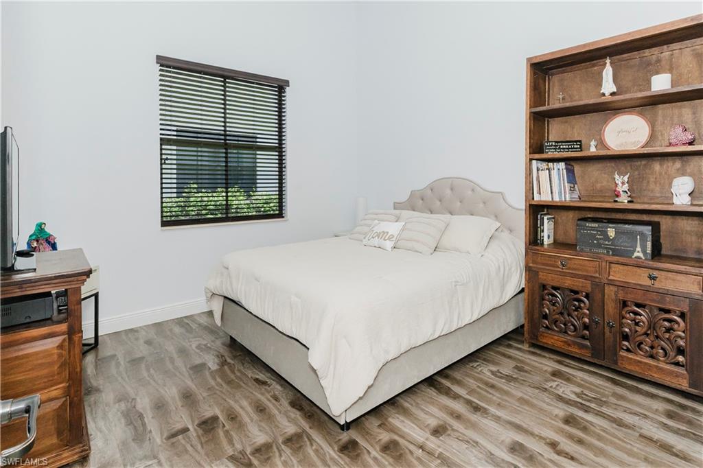 5169 Roma Street South Ave Maria, FL 34142 - Photo 30 of 49 a bedroom with a bed and a book shelf