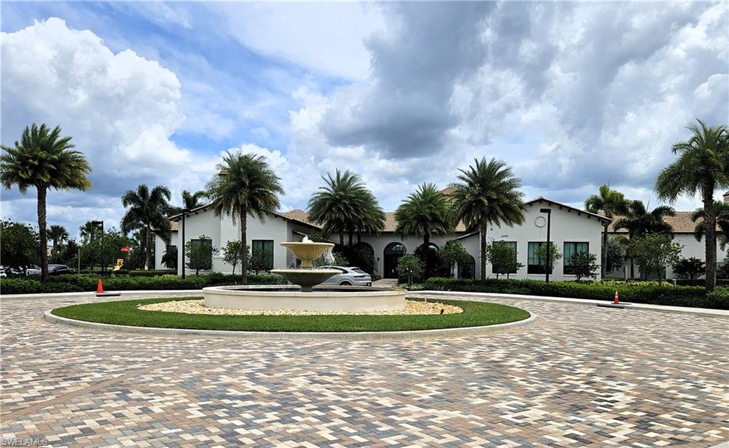 5169 Roma Street South Ave Maria, FL 34142 - Photo 45 of 49 a front view of a house with garden and trees