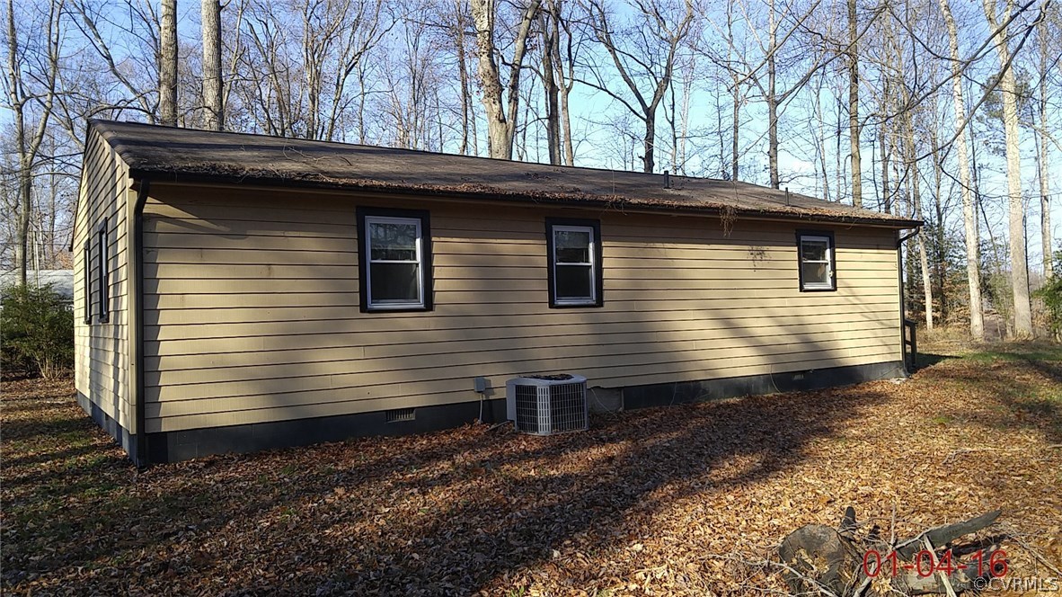 6731 Cherry Road Quinton, VA 23141 - Photo 2 of 13 a side view of a house with a yard