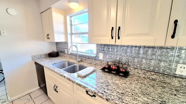 a kitchen with a sink and a window