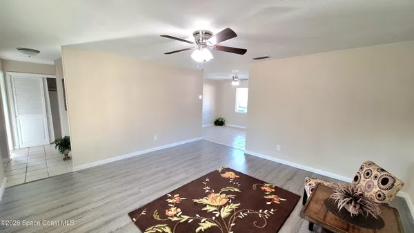 a view of a hallway with entryway wooden floor and front door