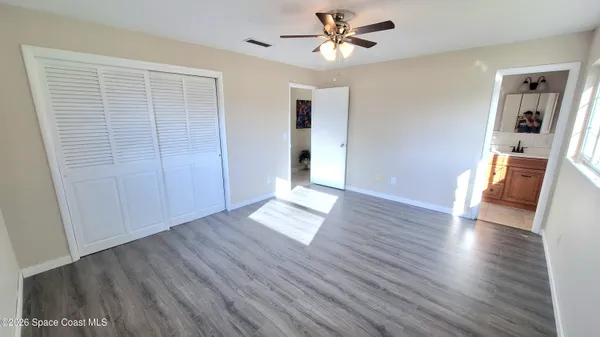 a view of empty room with wooden floor