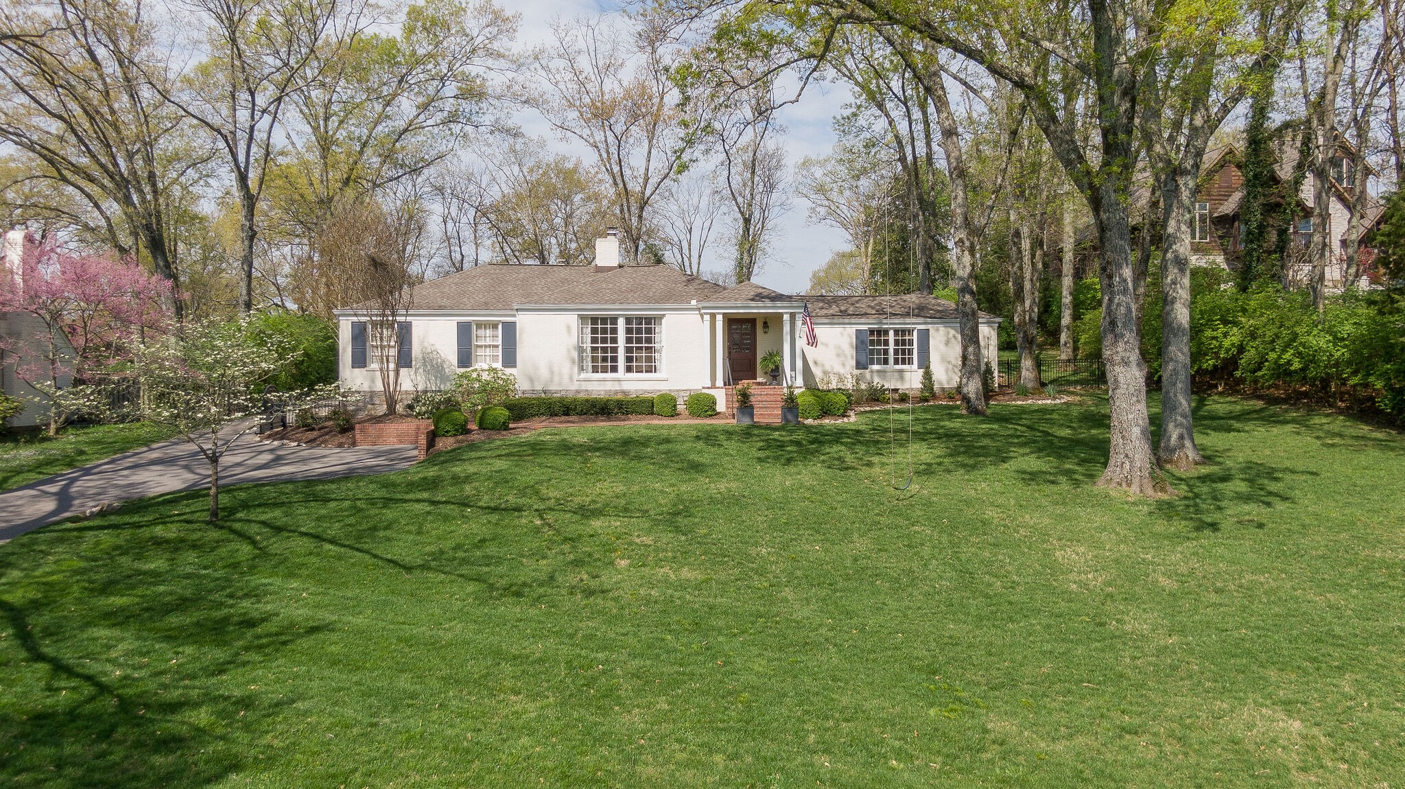 a front view of a house with a garden