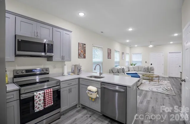 a kitchen with a sink stove and microwave