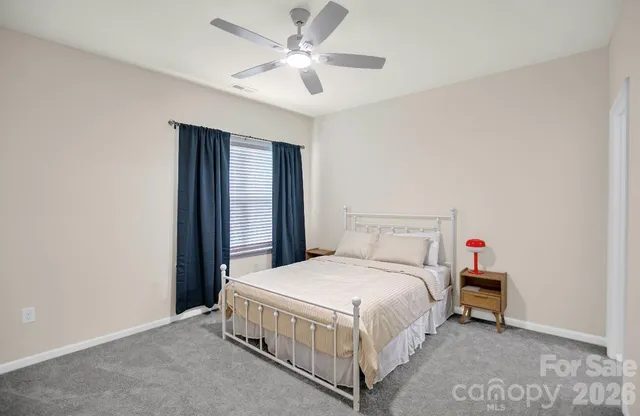 a bedroom with a bed and a ceiling fan