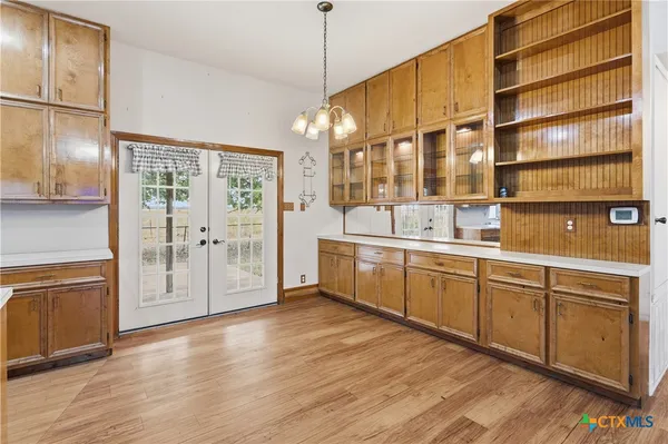 a kitchen with stainless steel appliances a sink cabinets and wooden floor